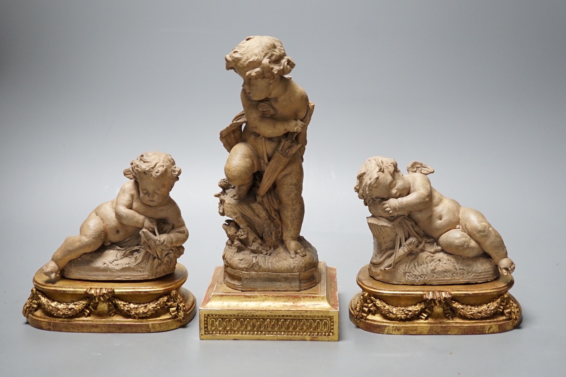 Two 19th century French terracotta cherubs and one other Cupid, after Clodion, all on giltwood stands, tallest 23.5cm